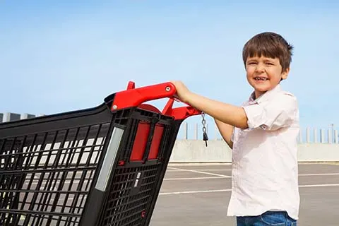 boy pushing shopping cart