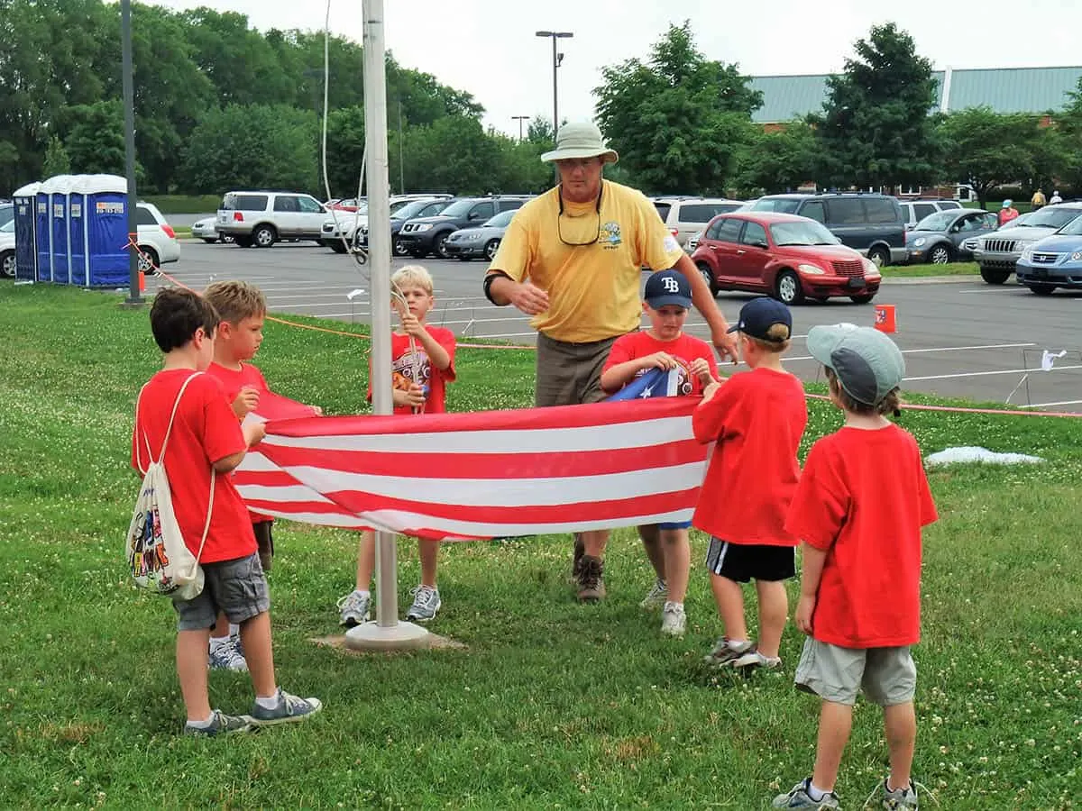 learning to fold flag at cub scout day camp