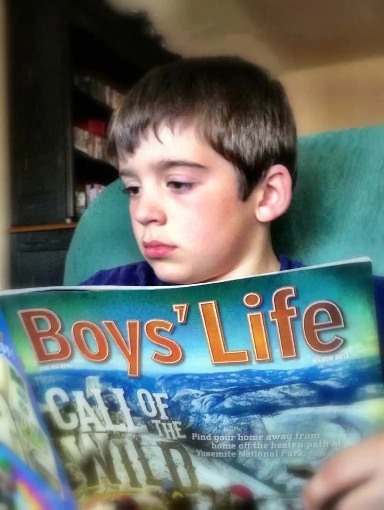 boy reading boys' life magazine
