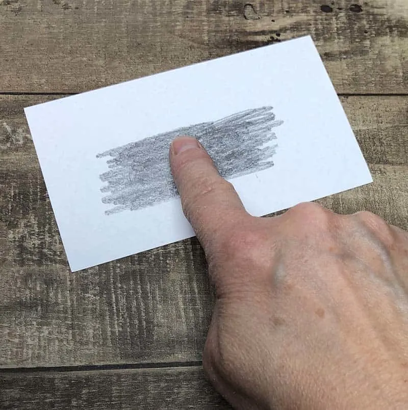 rub finger on pencil graphite for fingerprinting activity