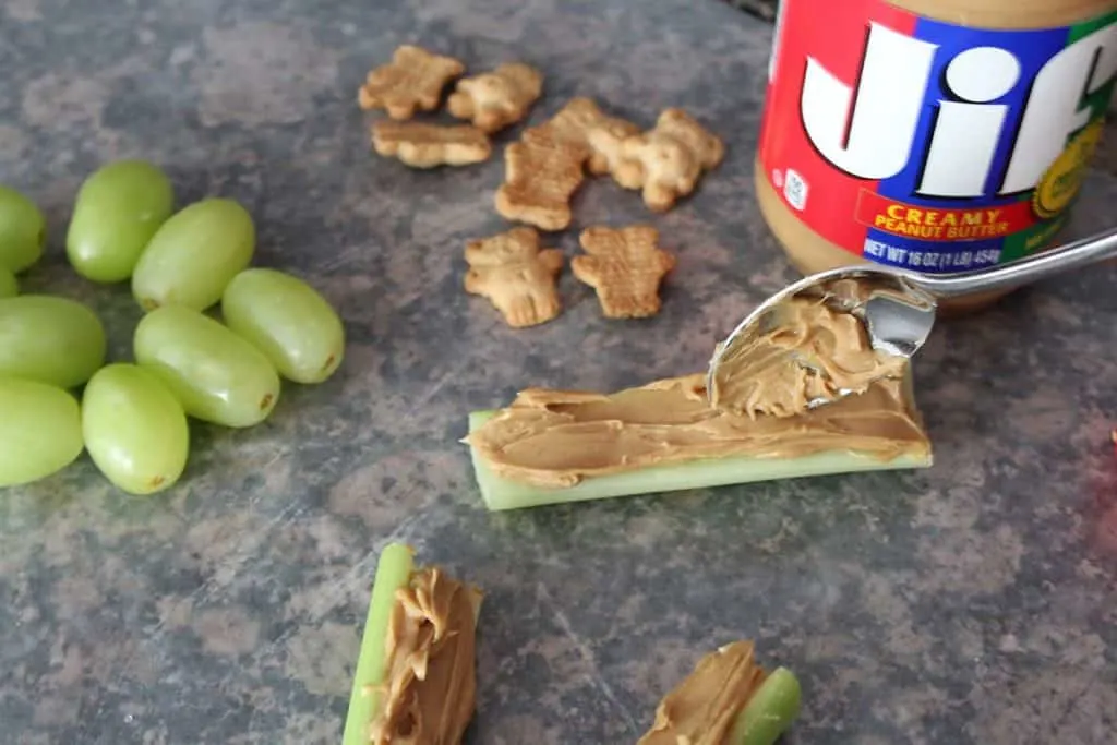 assembly of celery peanut butter healthy pinewood derby snack