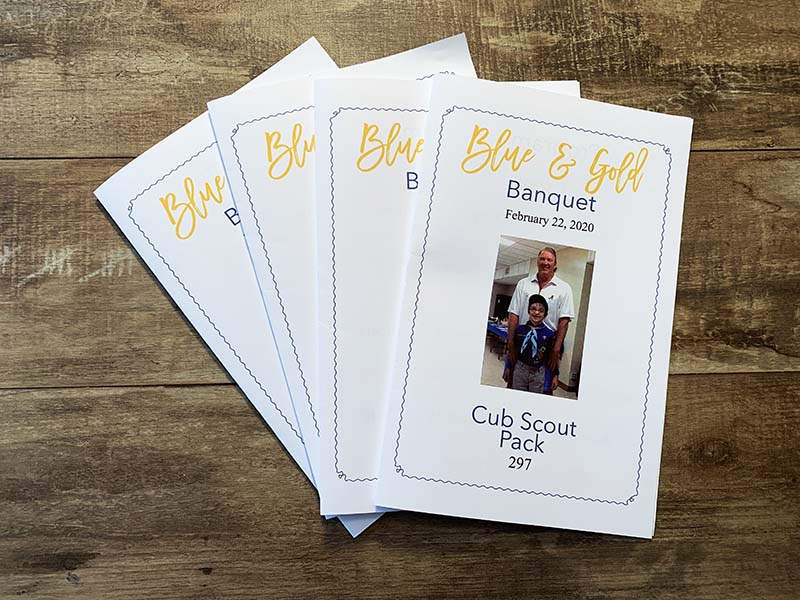 spread of blue and gold banquet programs