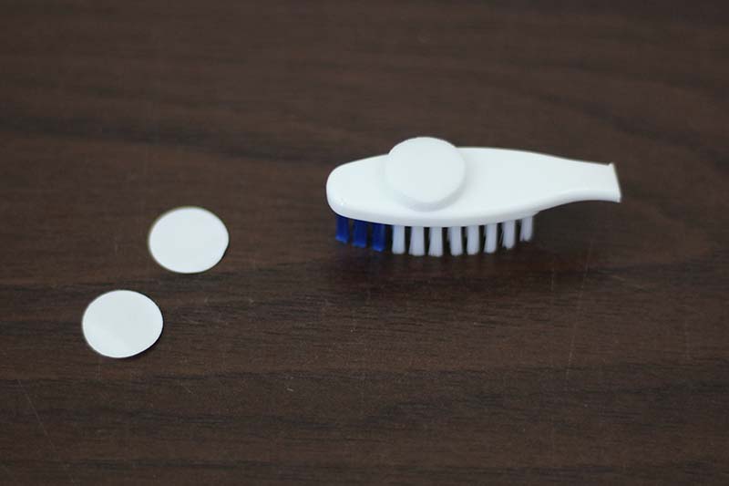 adhesive pad on toothbrush