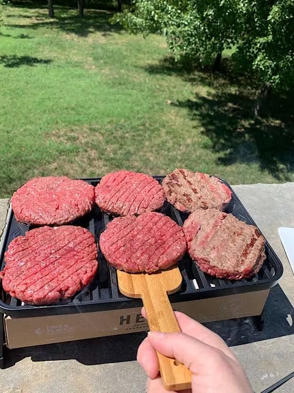 flipping burgers on grill