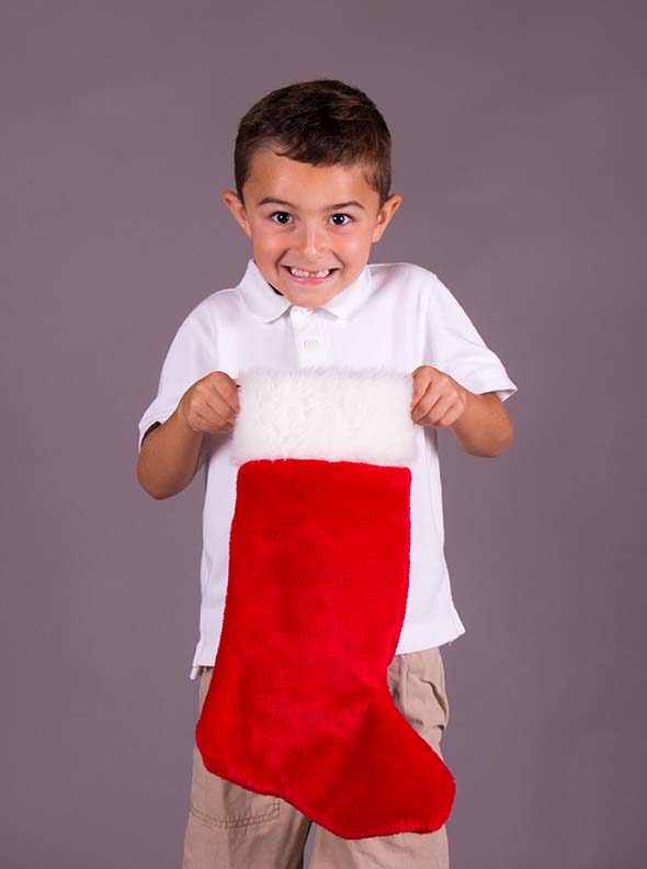 Little boy happy with Christmas stocking